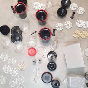 Close-up of disassembled camera lenses and filters used in stereography and photography.