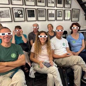 People wearing 3D glasses in a group photo at a photography and stereography event or workshop.
